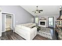 Cozy living room featuring a white sofa, a ceiling fan, and a fireplace at 7332 Quartz Rock Rd, Indianapolis, IN 46236