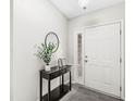 A neat entryway features tile floors and a decoratively furnished table, creating a welcoming first impression at 7656 Madden Ln, Fishers, IN 46038