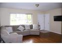 Inviting living room with hardwood floors, a comfortable sectional sofa, and abundant natural light at 8017 Chiltern Dr, Indianapolis, IN 46268