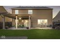 Spacious backyard patio with outdoor dining set, cafe lights, and room for entertaining at 8327 Andrusia Ln, Indianapolis, IN 46237