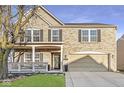 Two-story brick home featuring a charming front porch and well-maintained landscaping at 8327 Andrusia Ln, Indianapolis, IN 46237