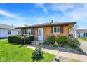 Traditional brick ranch with meticulously maintained front yard landscaping at 1043 E Castle Ave, Indianapolis, IN 46227