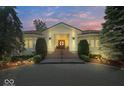 Elegant home entrance with a brick driveway, manicured shrubs and a classic door at 10919 Brigantine Dr, Indianapolis, IN 46256