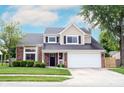Charming two-story home with a combination of brick and vinyl siding, plus an attached two-car garage at 10982 Gate Cir, Fishers, IN 46038
