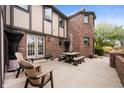 Spacious back patio with brick accents, perfect for outdoor dining and relaxation at 1122 Mill Run Dr, Noblesville, IN 46062