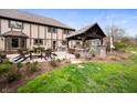 Large backyard with a covered patio, outdoor seating, a grill and a fire pit at 1122 Mill Run Dr, Noblesville, IN 46062