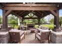 Beautiful outdoor living space with fireplace, comfortable seating and ceiling fan at 1122 Mill Run Dr, Noblesville, IN 46062