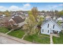 Aerial view of the property and surrounding neighborhood with well-maintained lawns and mature trees at 122 S 3Rd Ave, Beech Grove, IN 46107
