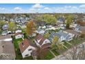 This aerial view shows the location in a suburban neighborhood with mature trees and sidewalks at 122 S 3Rd Ave, Beech Grove, IN 46107