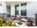 Cozy porch with outdoor seating, perfect for enjoying a peaceful moment amidst vibrant greenery and sunlight at 1242 Petit Verdot Dr, Westfield, IN 46074