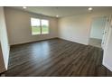 The bedroom features a large window for natural light and hardwood floors and an adjacent door into a closet at 1319 Fleming Dr, Greenfield, IN 46140