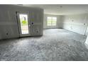 Bright, spacious room featuring natural light and a door to the exterior at 1319 Fleming Dr, Greenfield, IN 46140