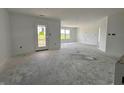 Bright living room with ample natural light, smooth walls, and a door leading to the outdoors at 1319 Fleming Dr, Greenfield, IN 46140