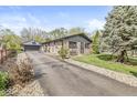 Charming stone home with detached garage, long driveway, and well-maintained landscaping at 1850 Cruft St, Indianapolis, IN 46203