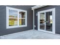 A backyard patio has sliding doors to access indoor with window to view outdoor scenery at 187 Luna Pl, Shelbyville, IN 46176