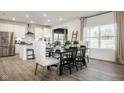 Open dining area with wood floors connects the kitchen to a bright window view at 187 Luna Pl, Shelbyville, IN 46176