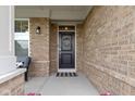 Close-up of the front door with wreath, showcasing brickwork and a welcoming entrance at 1979 Lunenburg Dr, Westfield, IN 46074