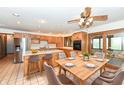 Open kitchen and dining area featuring wooden cabinetry, stainless steel appliances, and bar seating at 2308 Galahad Dr, Indianapolis, IN 46228