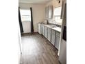 Efficient kitchen design with ample counter space, modern appliances, and wood laminate floors at 2632 Walker Ave, Indianapolis, IN 46203
