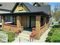 A welcoming front porch with brick pillars offers an inviting space for relaxation at 3320 E New York St, Indianapolis, IN 46201