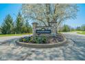 Welcome to Springmill Villages! Stone entrance sign surrounded by colorful flowers and lush greenery at 358 W Tansey Xing, Westfield, IN 46074