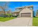Beautiful two-story home with a two-car garage, manicured lawn and charming curb appeal at 358 W Tansey Xing, Westfield, IN 46074