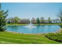 Scenic pond with a fountain, surrounded by lush greenery and neighborhood homes at 358 W Tansey Xing, Westfield, IN 46074