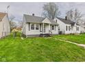 Attractive bungalow with a lush green lawn and sidewalk leading to the front door at 3826 Delaware St, Anderson, IN 46013