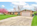 Attractive brick home with an attached two-car garage and well-maintained landscaping enhances its curb appeal at 4013 Colonial Dr, Anderson, IN 46012