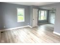 Bright and airy living room featuring neutral walls and stylish light wood flooring and ample natural light at 410 S 25Th Ave, Beech Grove, IN 46107