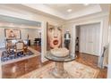 Grand foyer featuring herringbone wood floors, elegant decor, and an open view to living areas at 411 Sugar Tree Ln, Indianapolis, IN 46260
