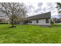 Expansive backyard featuring a screened-in porch, lush lawn, and mature trees perfect for relaxation and outdoor enjoyment at 5288 Ivy Hill Dr, Carmel, IN 46033
