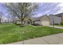 Charming single-story home featuring brick and vinyl siding with a well-manicured lawn and attached two-car garage at 5288 Ivy Hill Dr, Carmel, IN 46033