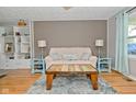 Bright living room with hardwood floors, stylish furniture, and ample natural light at 5693 W Walnut St, Greenwood, IN 46142