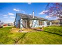Rear exterior showcasing a well-kept lawn, patio space, and blue siding at 5708 Crystal Bay W Dr, Plainfield, IN 46168