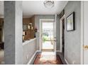 Inviting foyer with decorative rug and gray accent wall with views to the outside at 5886 N Peppereel Way, McCordsville, IN 46055