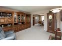 Spacious living room featuring large wooden cabinets, neutral paint, and an inviting dining area in the background at 6075 Bristlecone Dr, Fishers, IN 46038