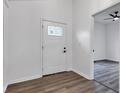 Bright entryway featuring wood-look flooring, a white front door with glass accents, and a view into another room at 614 Park Ave, Anderson, IN 46012