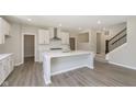 Bright kitchen with white cabinets, stainless steel appliances, and an island at 7215 Barrett Dr, Brownsburg, IN 46112