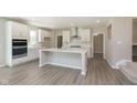 Open kitchen features white cabinets, stainless appliances, and center island at 7215 Barrett Dr, Brownsburg, IN 46112