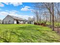 Expansive backyard featuring a play set, shed, partially fenced yard, and well-maintained lawn perfect for outdoor enjoyment at 8110 Madrone Ct, Indianapolis, IN 46236
