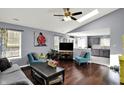 Bright and spacious living room with hardwood floors, skylight, modern furnishings, and an open layout at 8110 Madrone Ct, Indianapolis, IN 46236