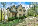 Angle view of brick home showing covered porch, landscaping and surrounding mature trees at 8191 S Bayview Ct, Trafalgar, IN 46181