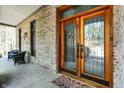 Covered front porch with double-door entry featuring glass inserts with decorative design at 8191 S Bayview Ct, Trafalgar, IN 46181