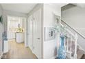 Bright entryway featuring hardwood floors, white trim, and a view into the adjacent kitchen area at 8332 Tanager Ln, Indianapolis, IN 46256