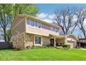 Well-maintained home with a stone and siding exterior, lush lawn, and a neatly manicured front yard at 8332 Tanager Ln, Indianapolis, IN 46256