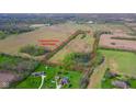 An aerial view of the property with surrounding acreage and property lines outlined at 1004 Shepherd Rd, Anderson, IN 46012