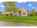 Beautiful stone home with manicured lawn and well-maintained landscaping at 10794 Pine Needle Ct, Fishers, IN 46037