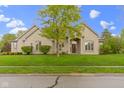 Charming stone home with manicured lawn and mature landscaping at 10794 Pine Needle Ct, Fishers, IN 46037