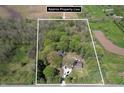 Aerial view of a secluded property surrounded by lush greenery, showcasing the expansive lot at 10912 N County Road 950 E, Brownsburg, IN 46112